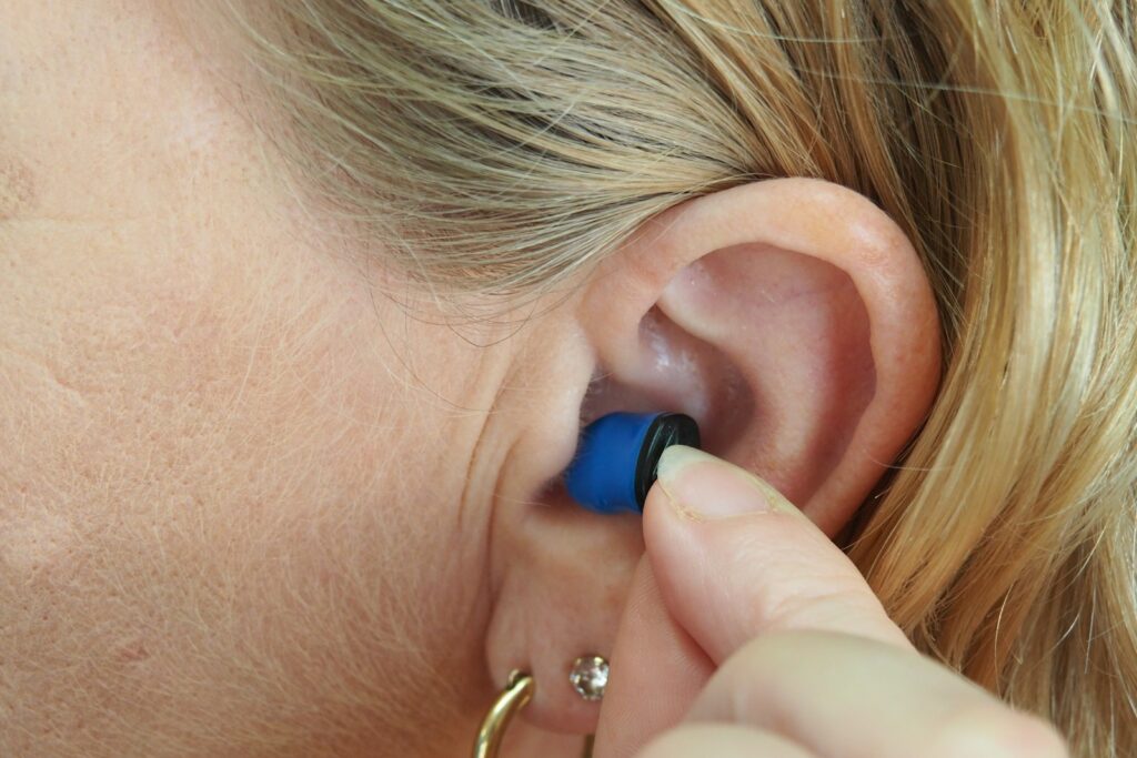 woman wearing blue stud earring