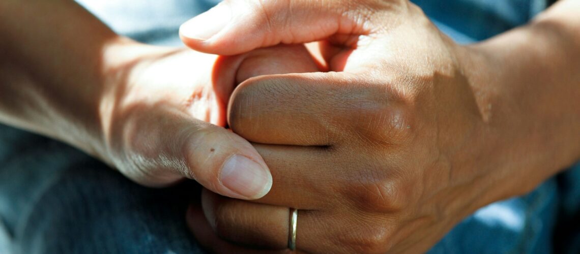 person wearing gold wedding band