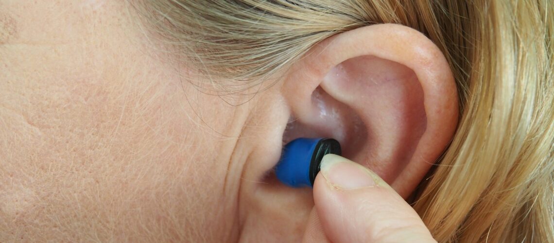 woman wearing blue stud earring